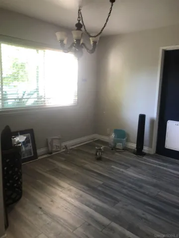 a room with a wooden floor and a window