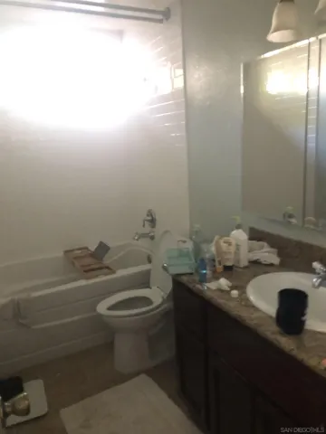a bathroom with a sink toilet and mirror