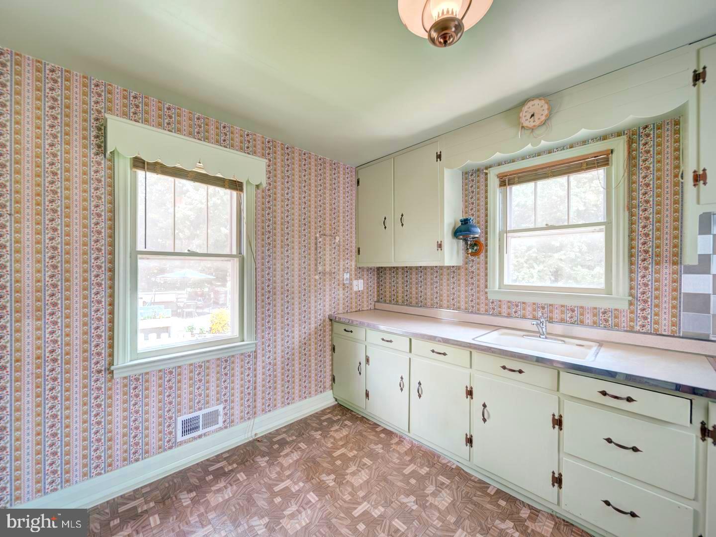 6505 Beechwood Road Baltimore, MD 21239 - Photo 15 of 46 a kitchen with granite countertop a window sink and cabinets