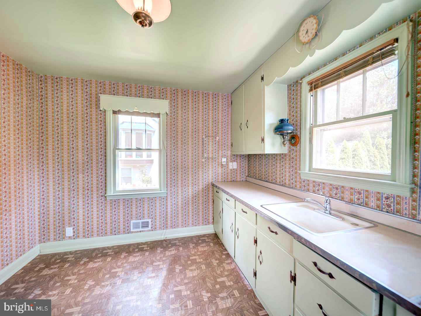 6505 Beechwood Road Baltimore, MD 21239 - Photo 17 of 46 a large white kitchen with a window