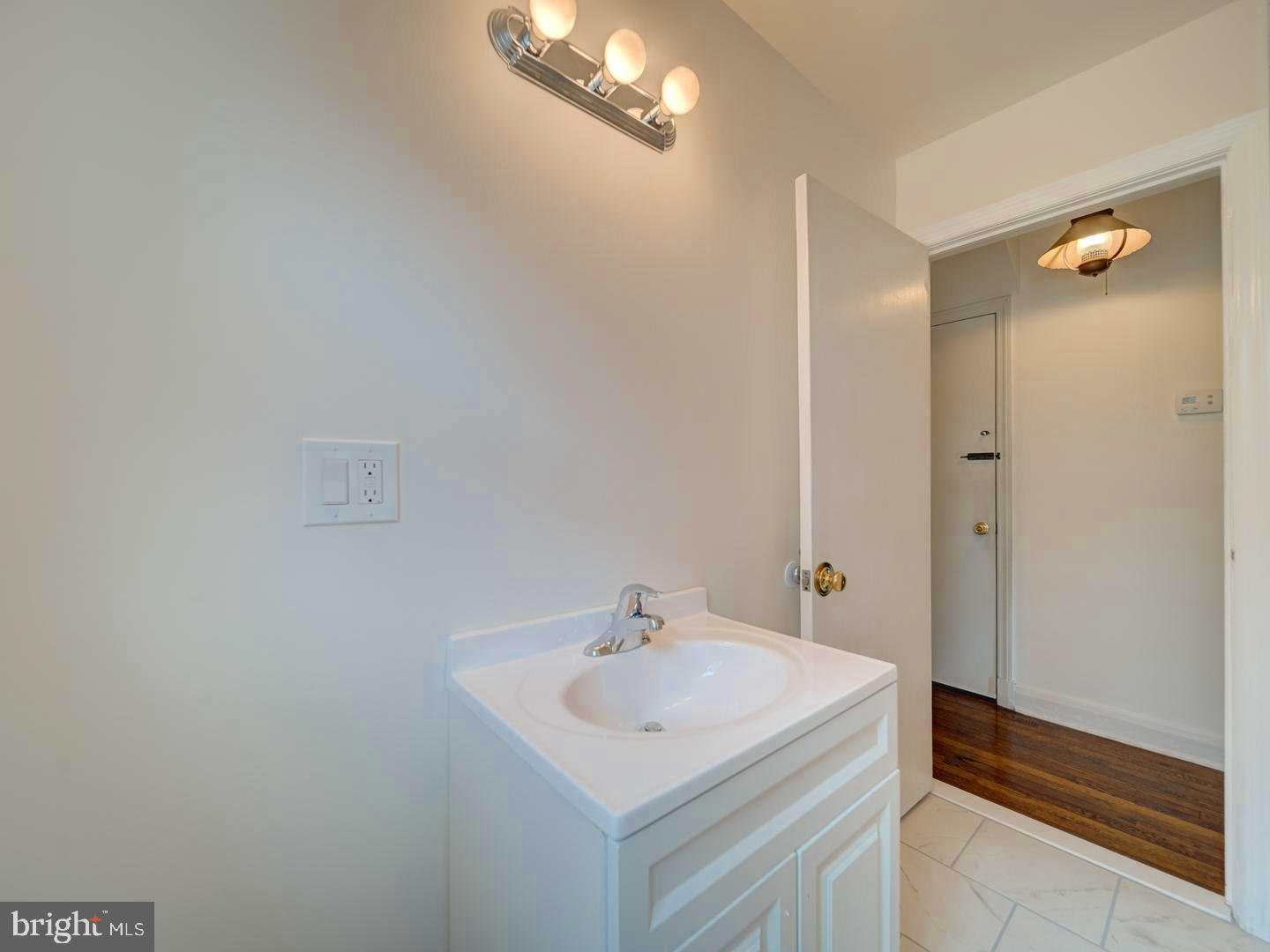 6505 Beechwood Road Baltimore, MD 21239 - Photo 23 of 46 a bathroom with a sink and a mirror