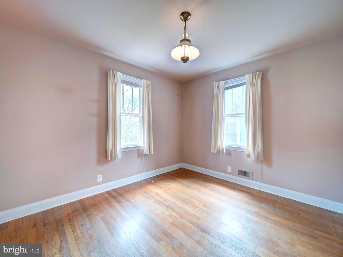 6505 Beechwood Road Baltimore, MD 21239 - Photo 25 of 46 a view of an empty room with wooden floor and a window