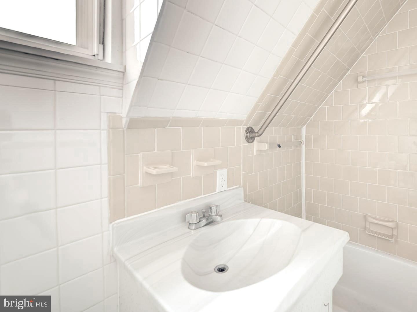 6505 Beechwood Road Baltimore, MD 21239 - Photo 38 of 46 a bathroom with a sink and a bathtub