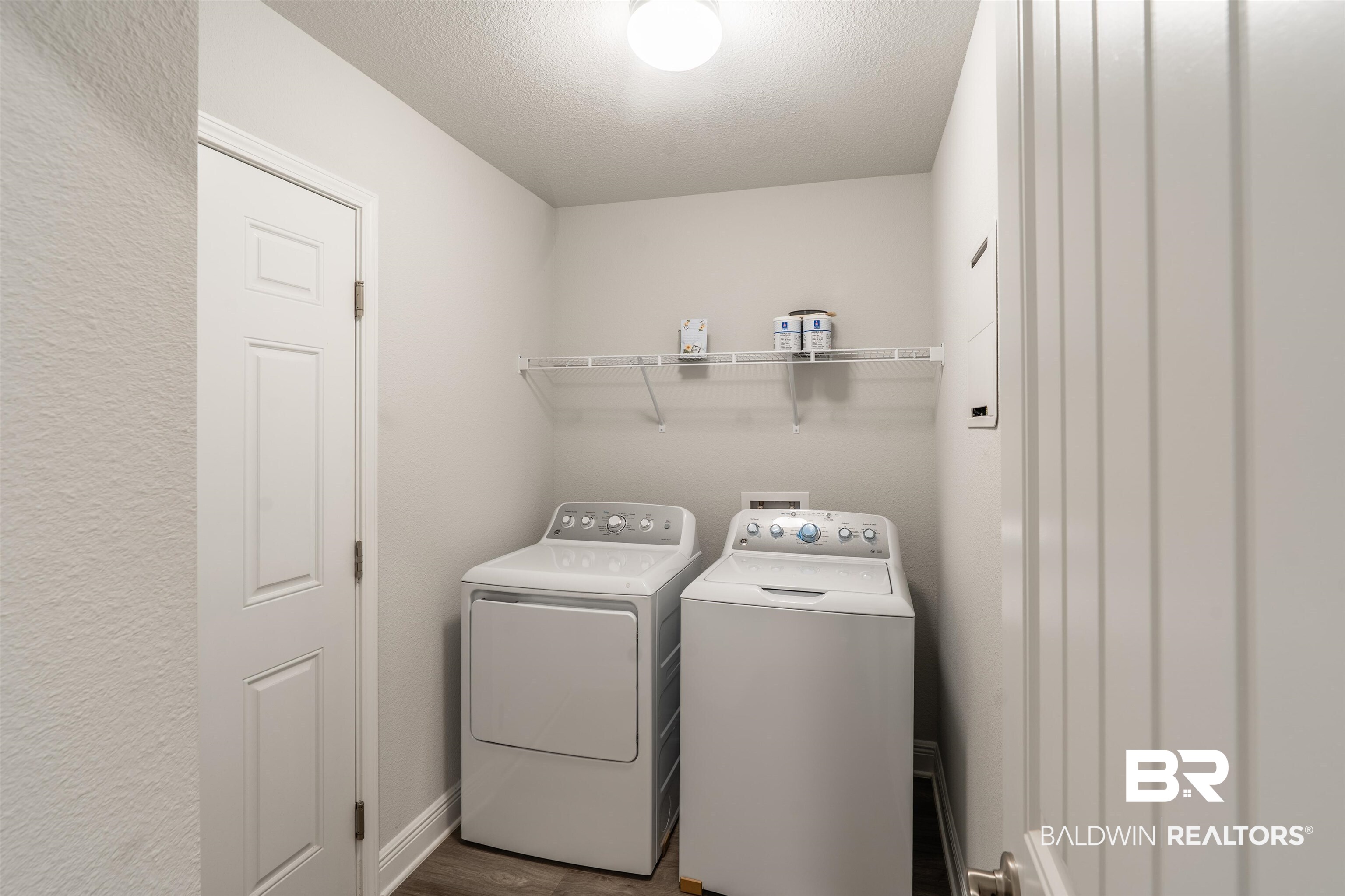 1906 Stonepine Drive South Semmes, AL 36575 - Photo 14 of 30 Laundry room featuring washer and dryer, dark wood-style floors, and a textured ceiling