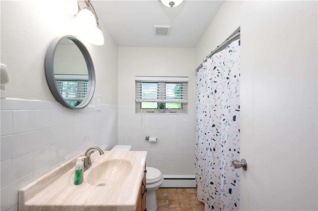 120 West Sunbury Road Butler, PA 16001 - Photo 22 of 46 a bathroom with a sink a mirror and a toilet