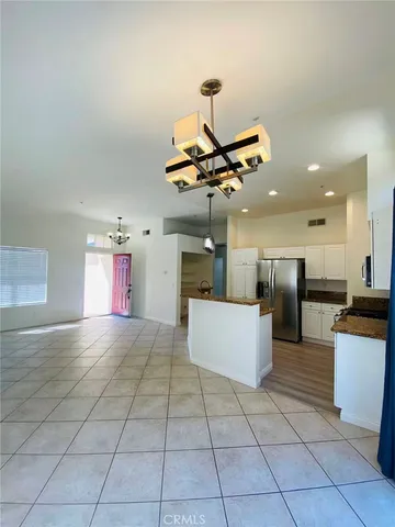 a kitchen with kitchen island stainless steel appliances a stove a sink cabinets and a counter top