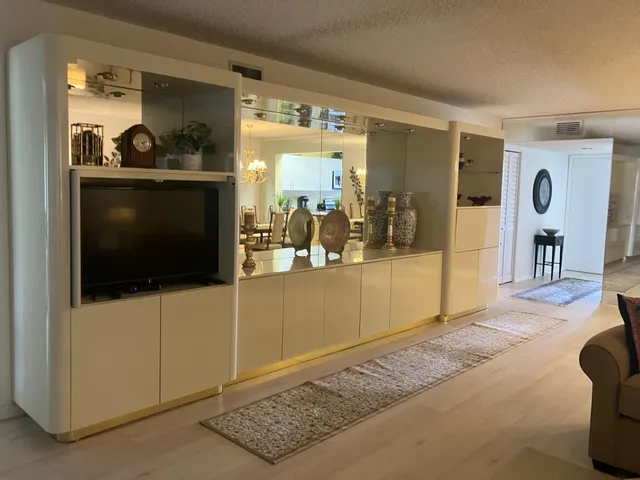 a living room with furniture a flat screen tv and a view of living room