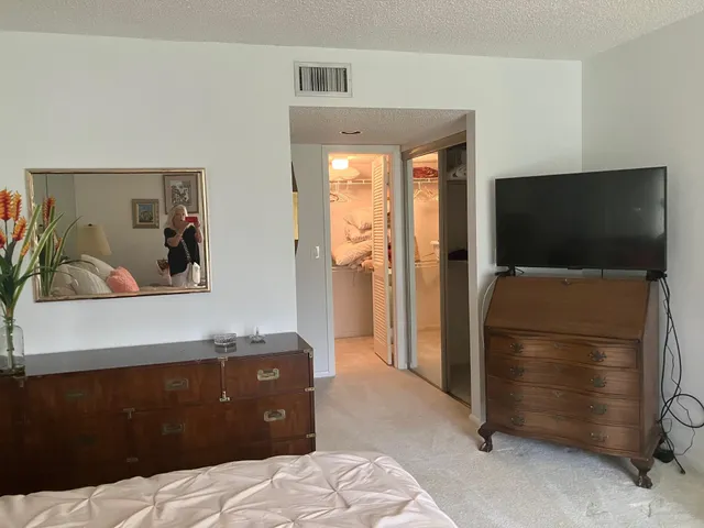 a bedroom with a bed and a television