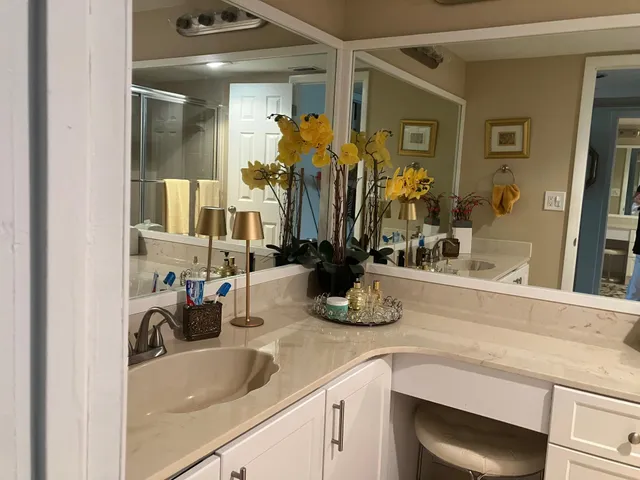 a kitchen with sink and mirror