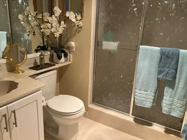 a bathroom with a toilet sink and shower