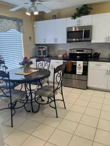 a kitchen with stainless steel appliances kitchen island granite countertop a sink and cabinets