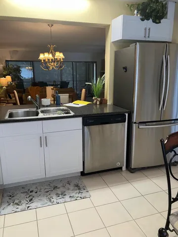 a kitchen with stainless steel appliances granite countertop a refrigerator and a stove