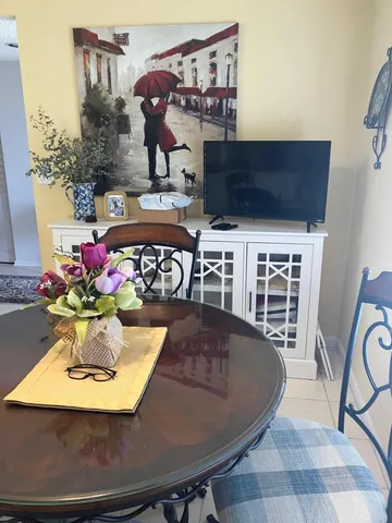 a view of a dining room with furniture and chandelier
