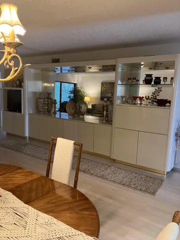 a kitchen view with stainless steel appliances kitchen island granite countertop a sink and cabinets