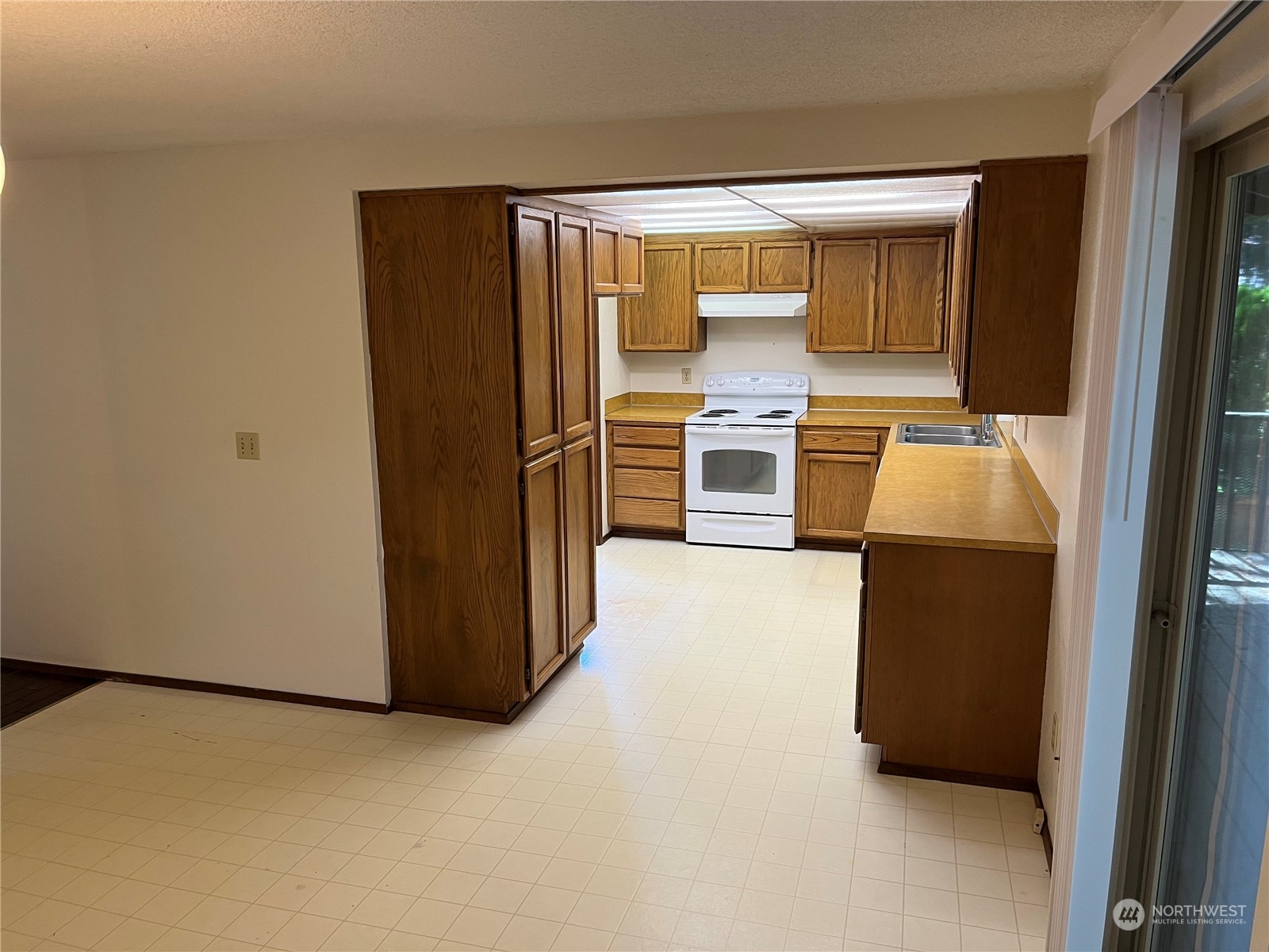 14005 149th Place Southeast Renton, WA 98059 - Photo 8 of 35 a hallway with cabinets and refrigerator
