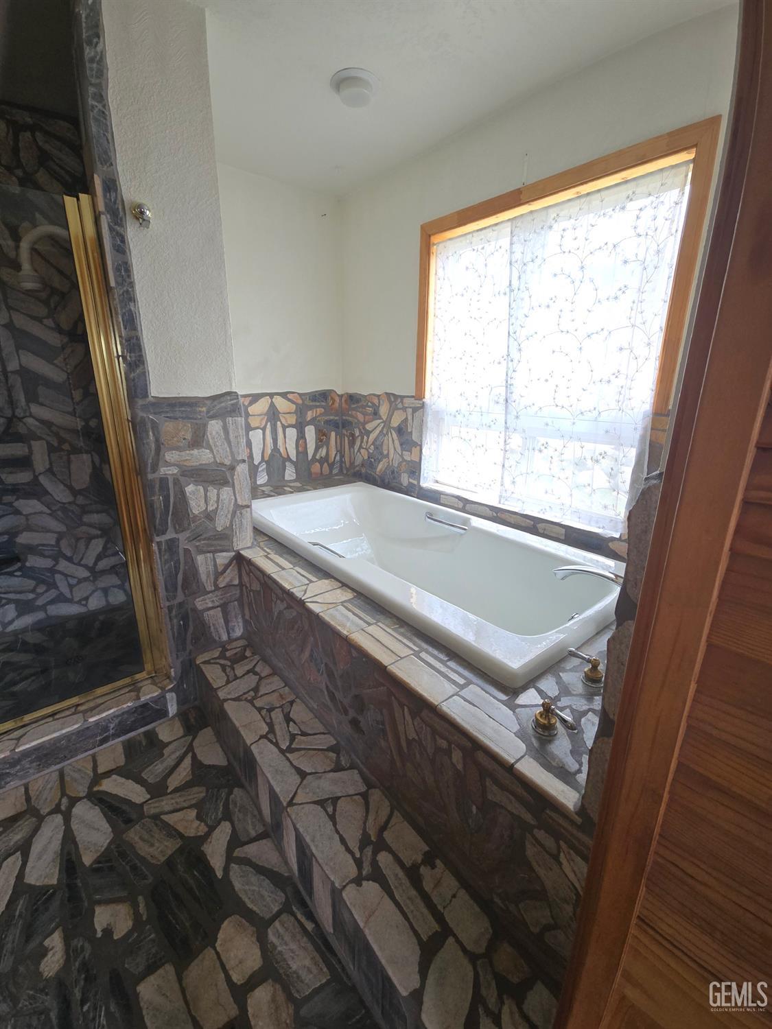 Undisclosed Address Weldon, CA 93283 - Photo 22 of 43 a bath tub sitting in a bathroom next to a window