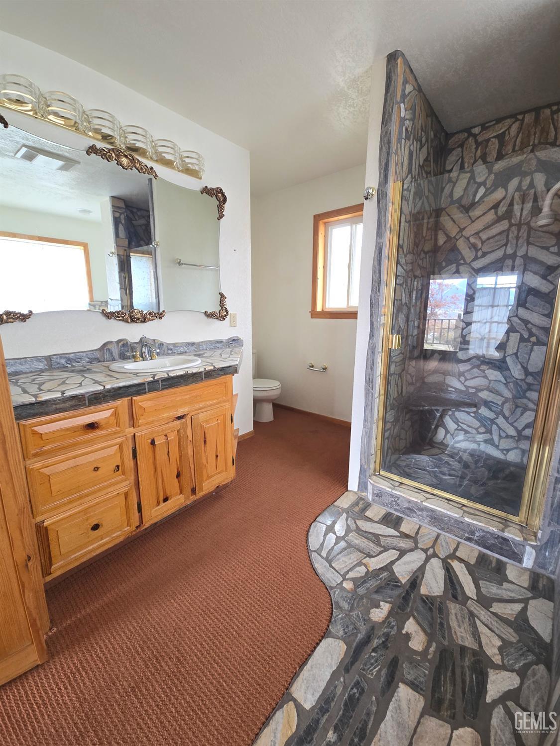 Undisclosed Address Weldon, CA 93283 - Photo 24 of 43 a spacious bathroom with a granite countertop sink a mirror and shower