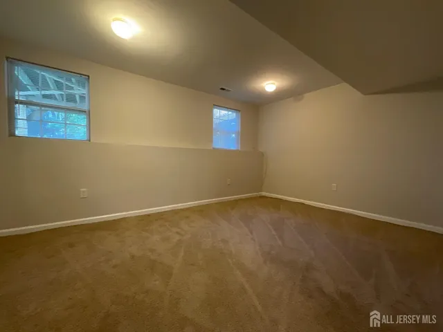 an empty room with a projector and windows