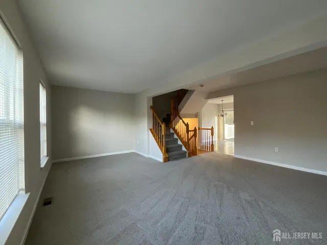 a view of a livingroom with wooden floor and a window