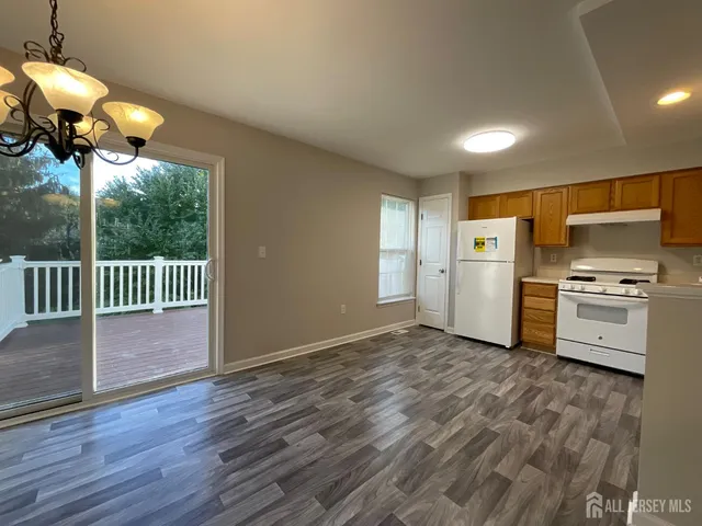 a view of a kitchen with a sink wooden floor and a window