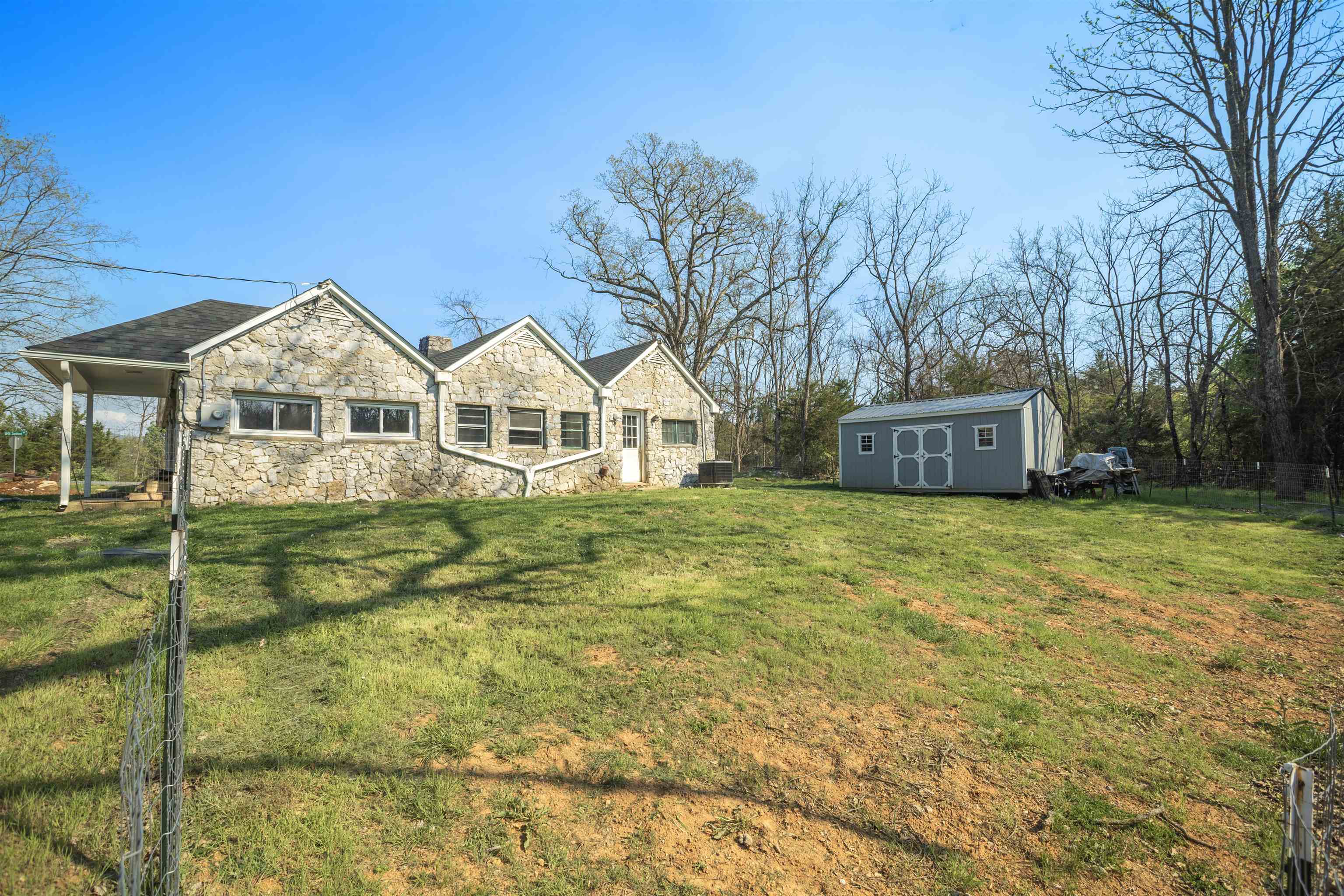 1641 Smithland Road Harrisonburg, VA 22802 - Photo 3 of 44 a view of a white house with a yard and large trees