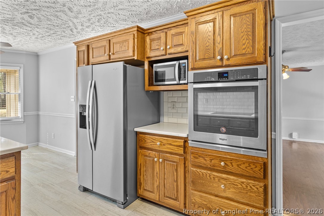 7756 Dragonhead Road Fayetteville, NC 28311 - Photo 15 of 42 a kitchen with stainless steel appliances granite countertop cabinets and a refrigerator