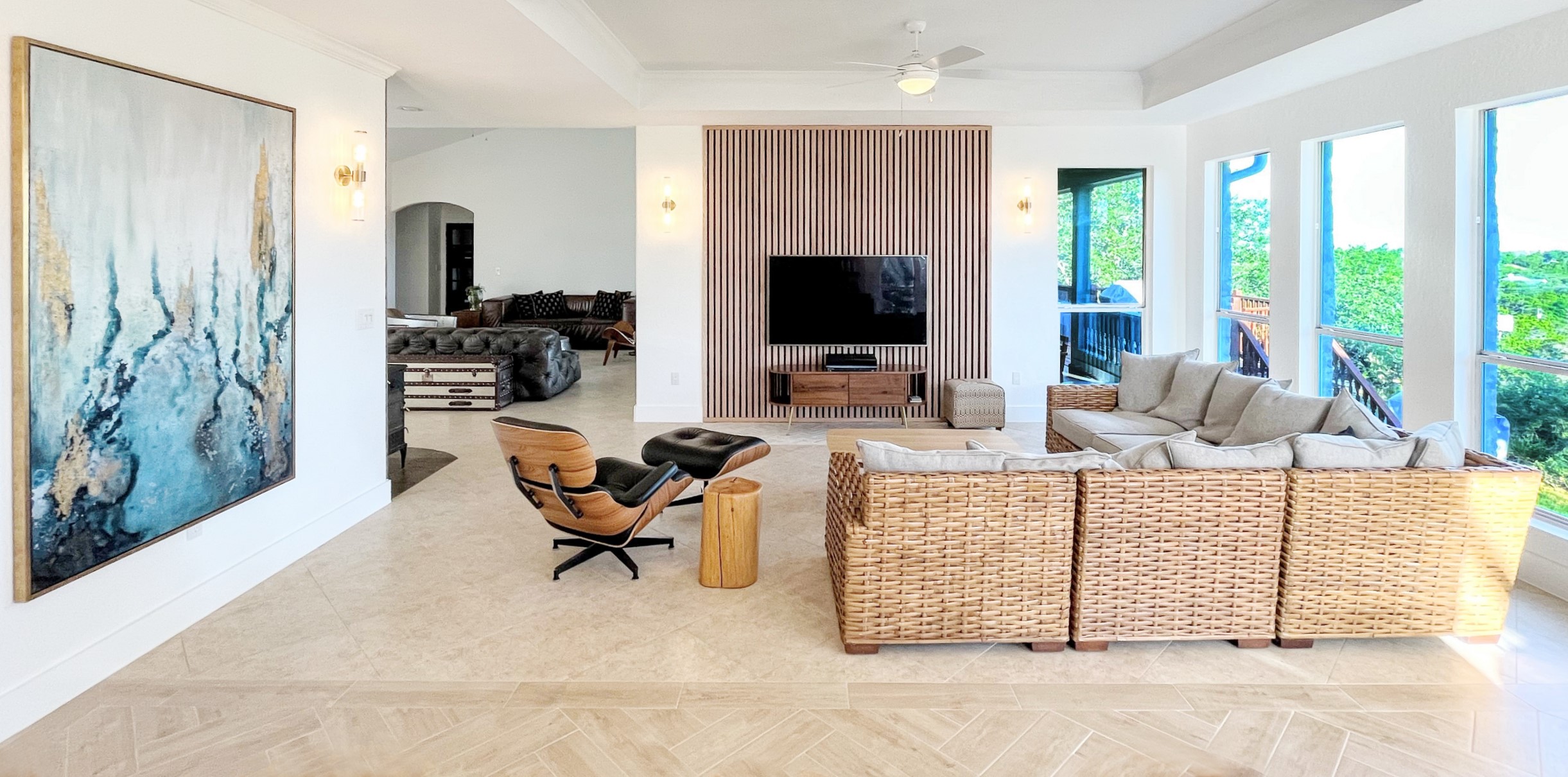 1015 Westland Ridge Road Dripping Springs, TX 78620 - Photo 1 of 32 Sun-filled living space offers soaring vaulted ceilings and expansive windows framing serene outdoor views.