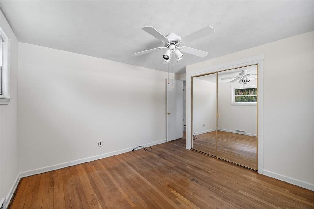 86 Talmadge Drive Springfield, MA 01118 - Photo 14 of 33 an empty room with wooden floor and door