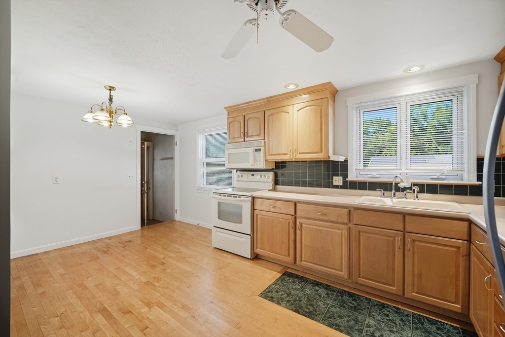 86 Talmadge Drive Springfield, MA 01118 - Photo 18 of 33 a spacious bathroom with a granite countertop sink a large mirror and a bathtub with shower