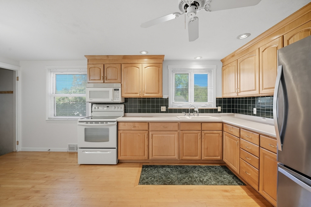 86 Talmadge Drive Springfield, MA 01118 - Photo 19 of 33 a kitchen with granite countertop a sink stainless steel appliances and cabinets