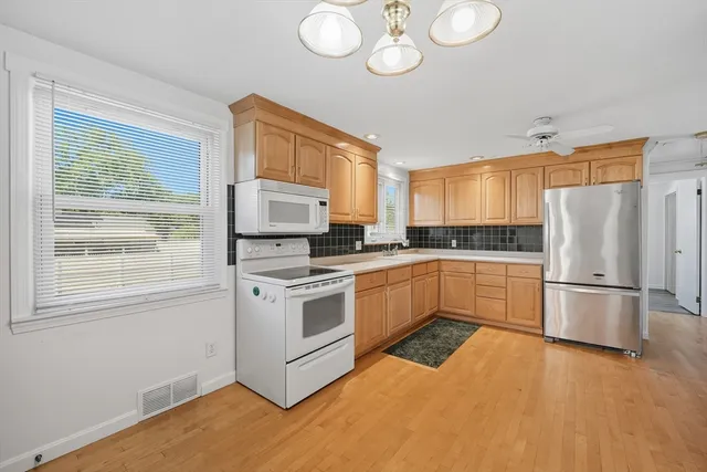 a kitchen with a white cabinets and white appliances
