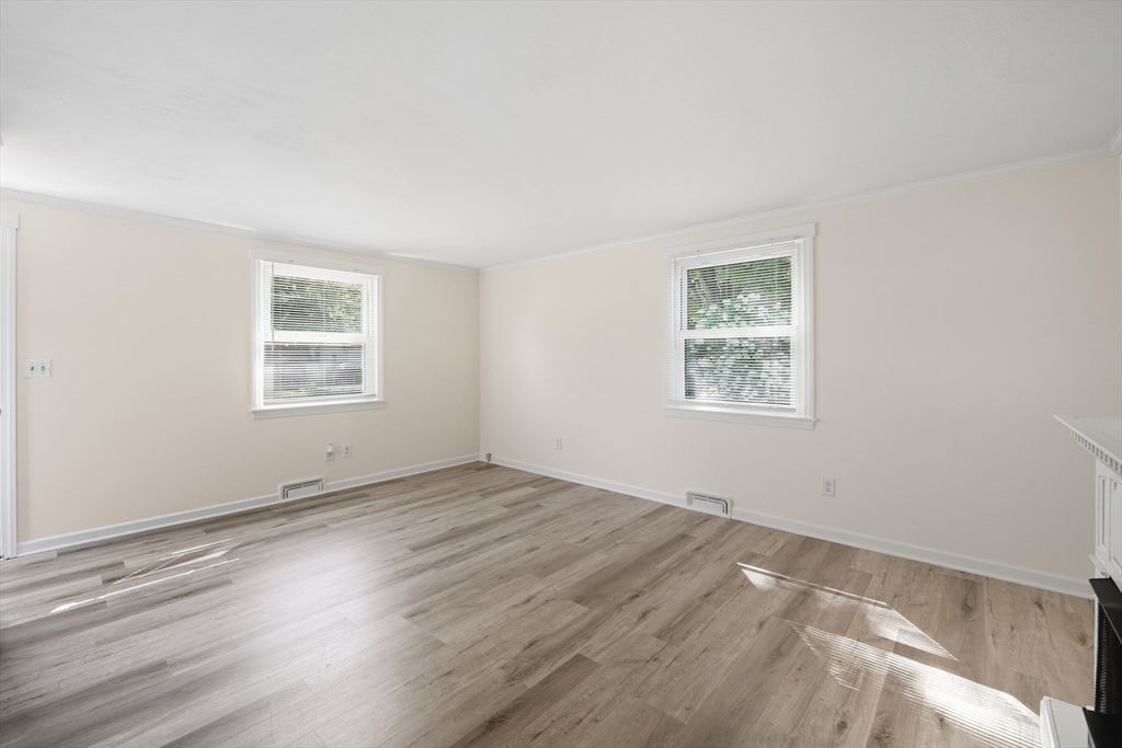 86 Talmadge Drive Springfield, MA 01118 - Photo 8 of 33 an empty room with wooden floor and windows