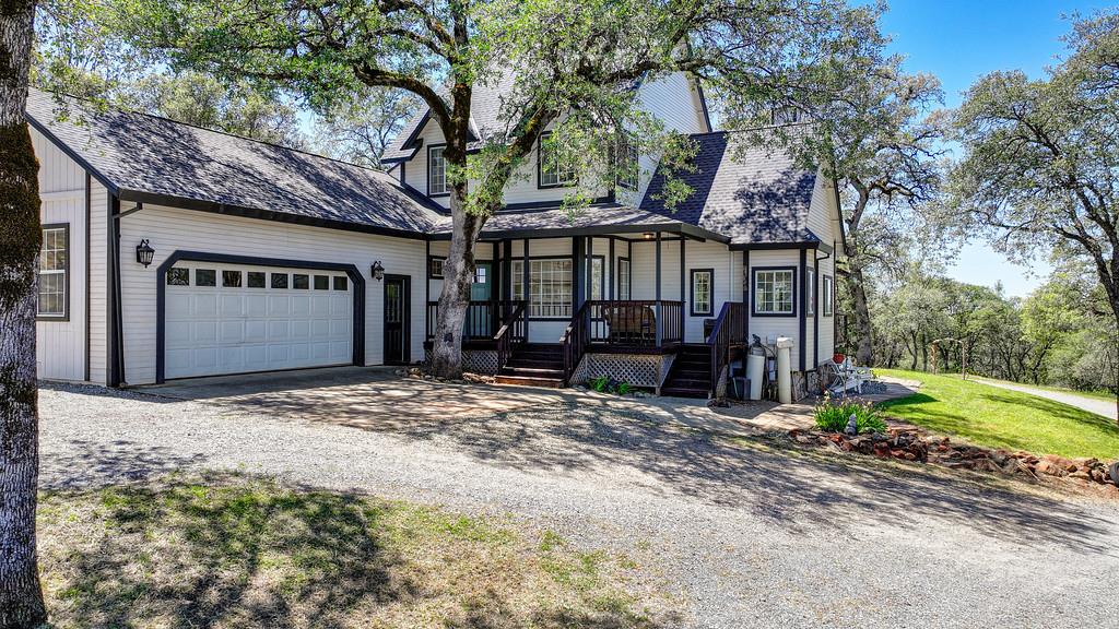 3154 Twin K Road Pilot Hill, CA 95664 - Photo 5 of 89 a view of a house with large trees and a barn