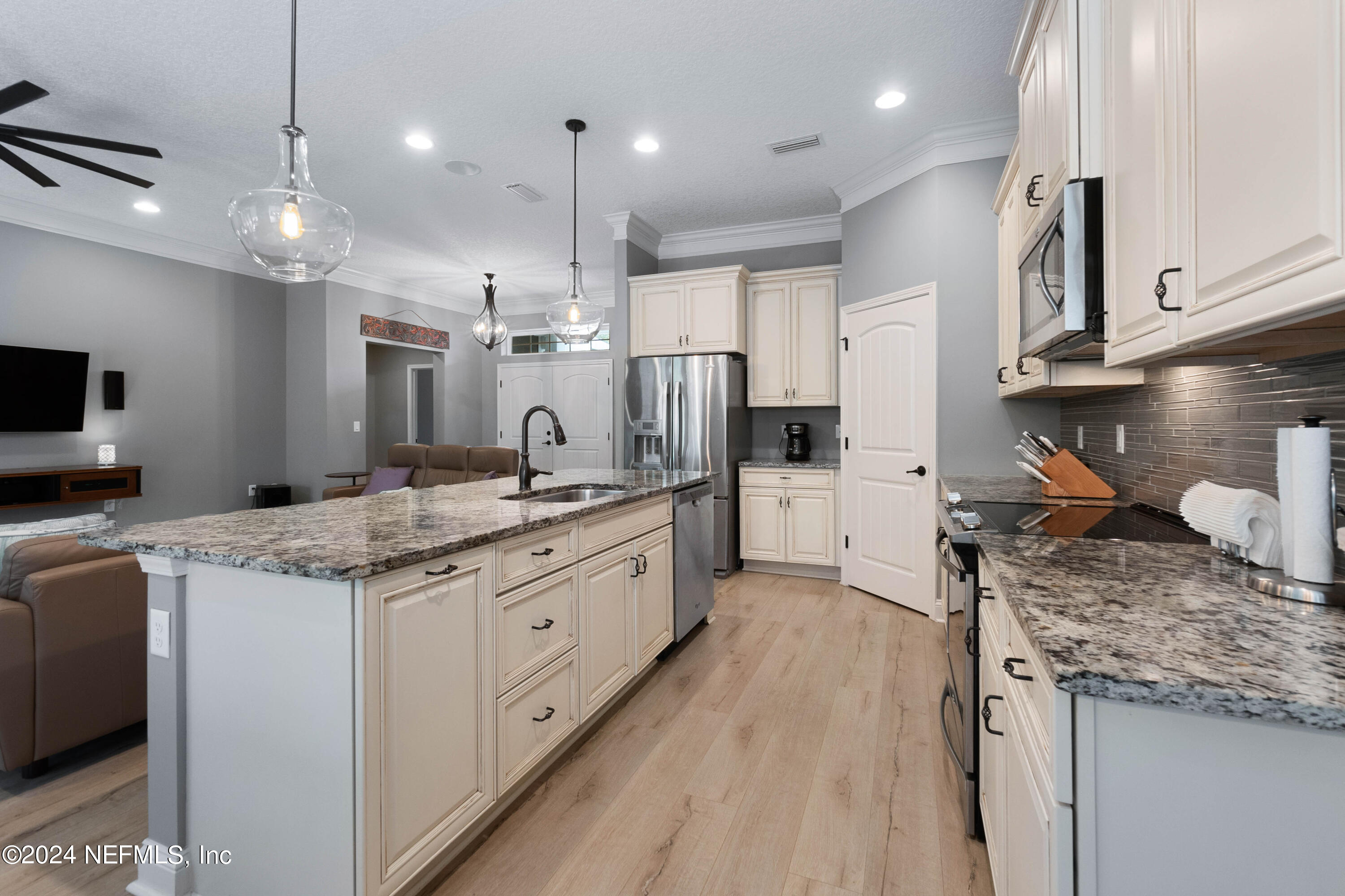 847 Oak Ridge Road St. Augustine, FL 32086 - Photo 13 of 36 a kitchen with stainless steel appliances granite countertop a stove a sink a refrigerator and a oven