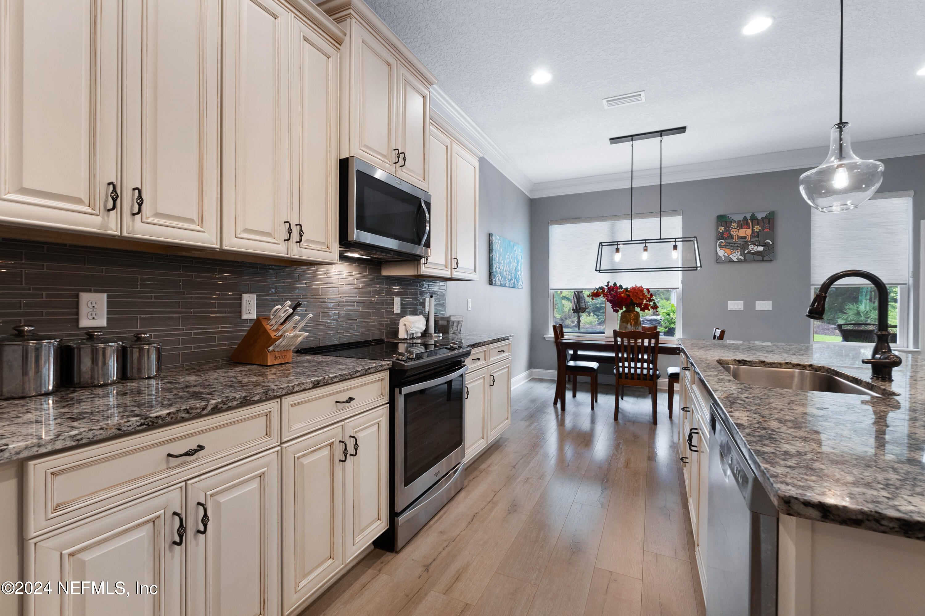 847 Oak Ridge Road St. Augustine, FL 32086 - Photo 14 of 36 a kitchen with granite countertop a sink a counter space appliances and cabinets
