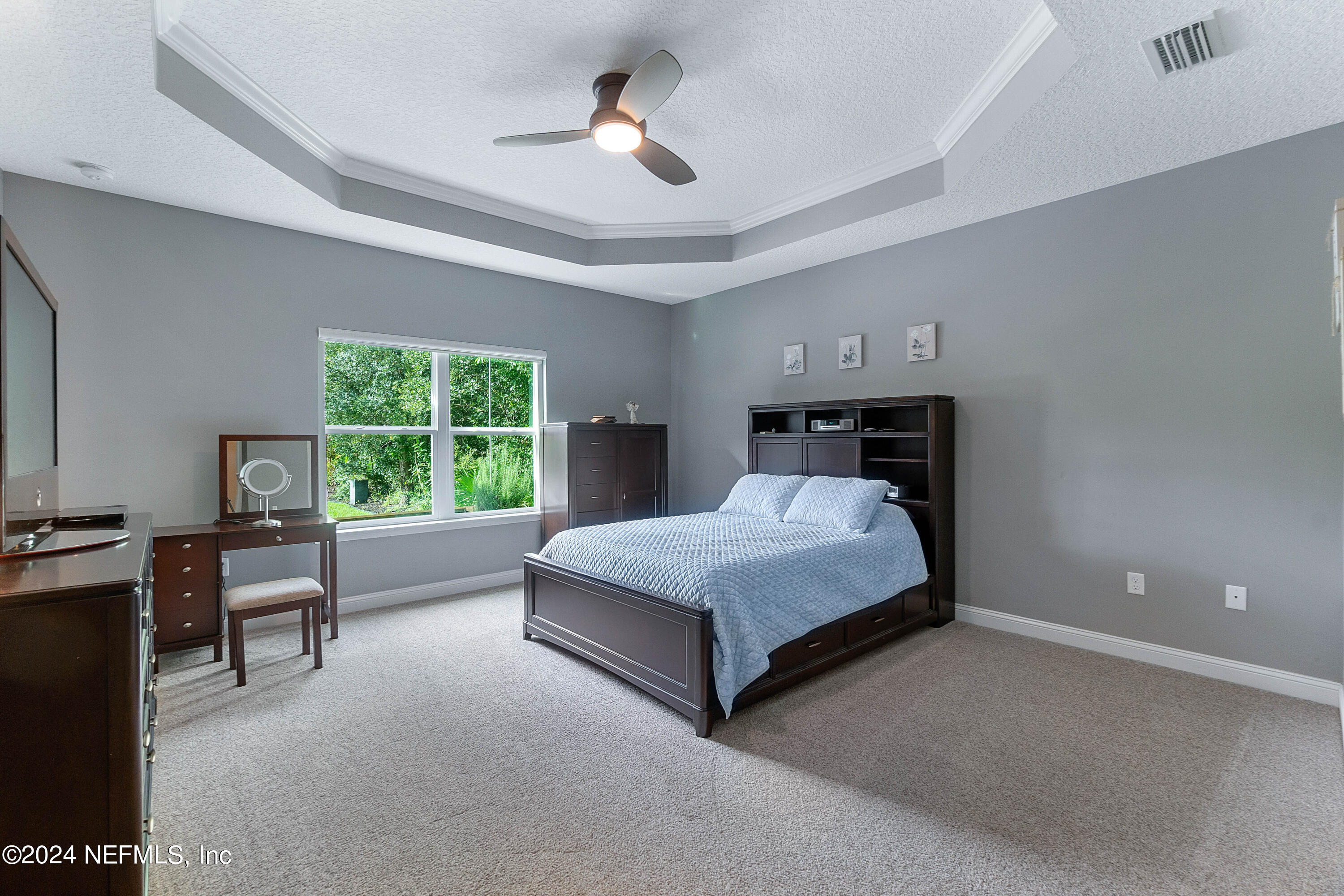 847 Oak Ridge Road St. Augustine, FL 32086 - Photo 15 of 36 a bed sitting in a spacious bedroom next to a window