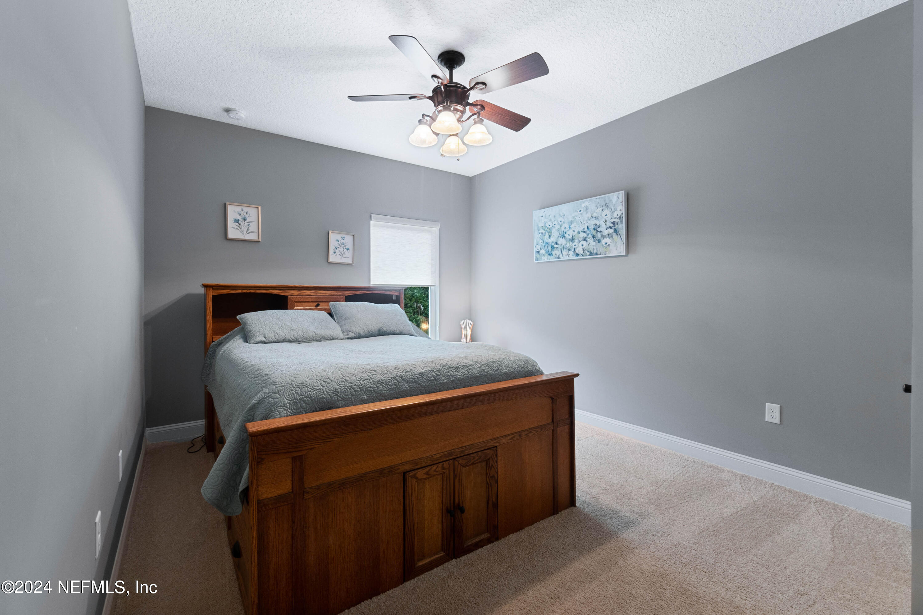 847 Oak Ridge Road St. Augustine, FL 32086 - Photo 20 of 36 a bedroom with a bed and a ceiling fan