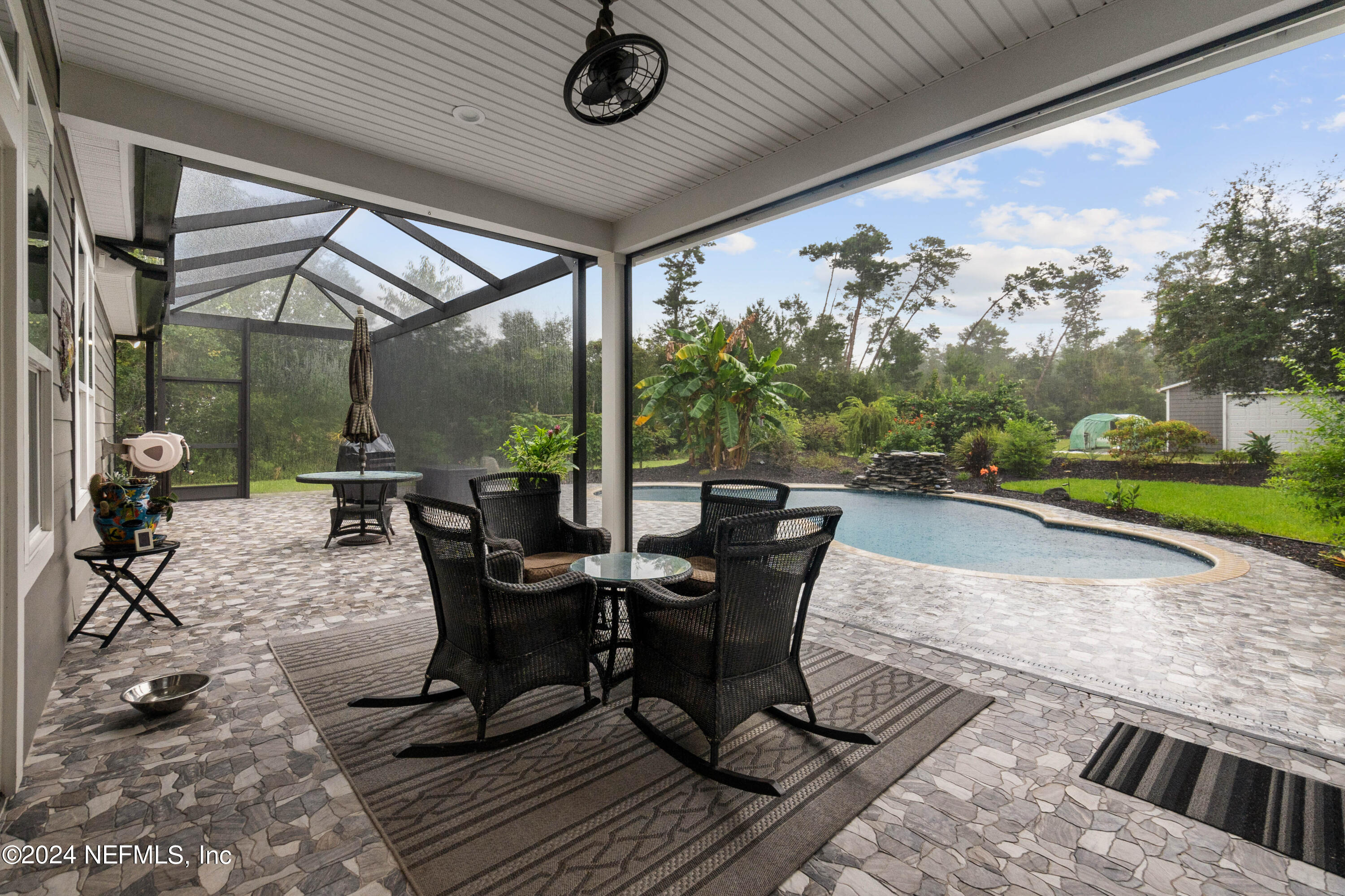 847 Oak Ridge Road St. Augustine, FL 32086 - Photo 23 of 36 a view of a patio with table and chairs and potted plants