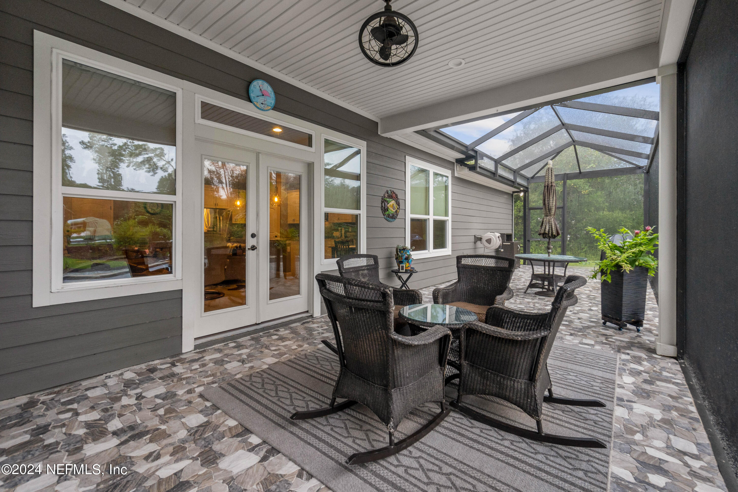 847 Oak Ridge Road St. Augustine, FL 32086 - Photo 24 of 36 a view of a dinning table and chairs in patio of the house