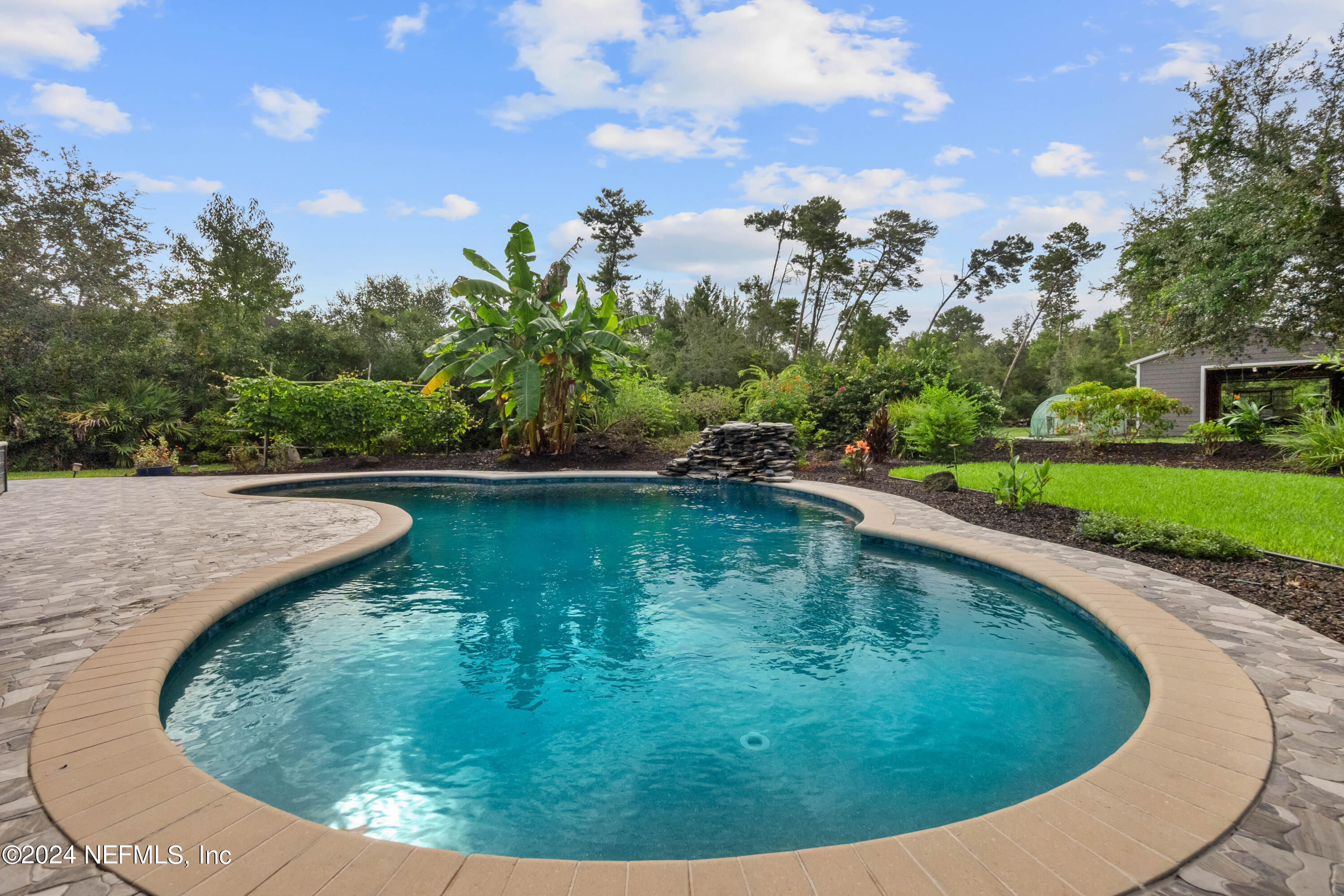 847 Oak Ridge Road St. Augustine, FL 32086 - Photo 25 of 36 a view of a swimming pool with a yard