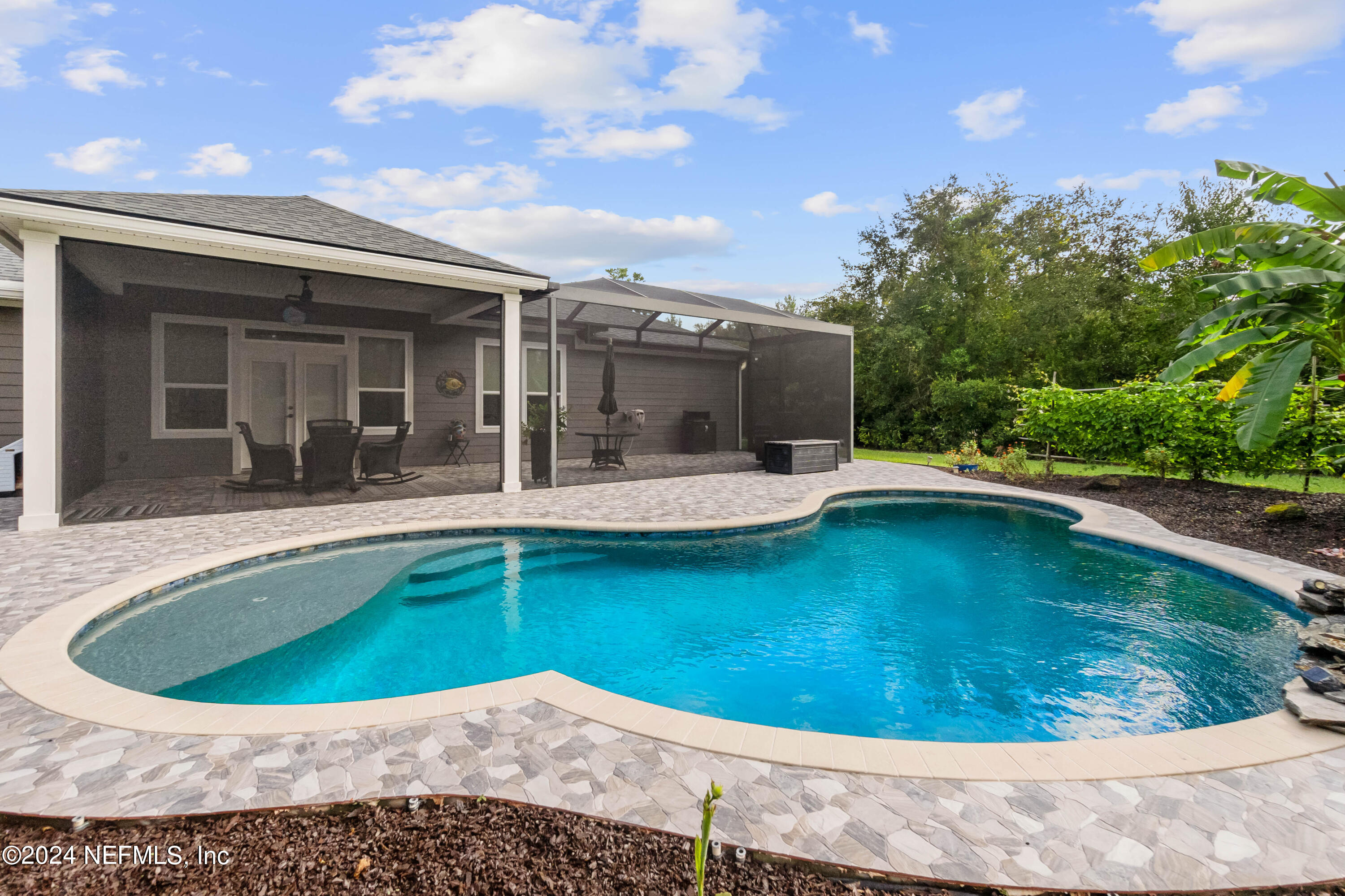 847 Oak Ridge Road St. Augustine, FL 32086 - Photo 26 of 36 a view of a swimming pool with a patio