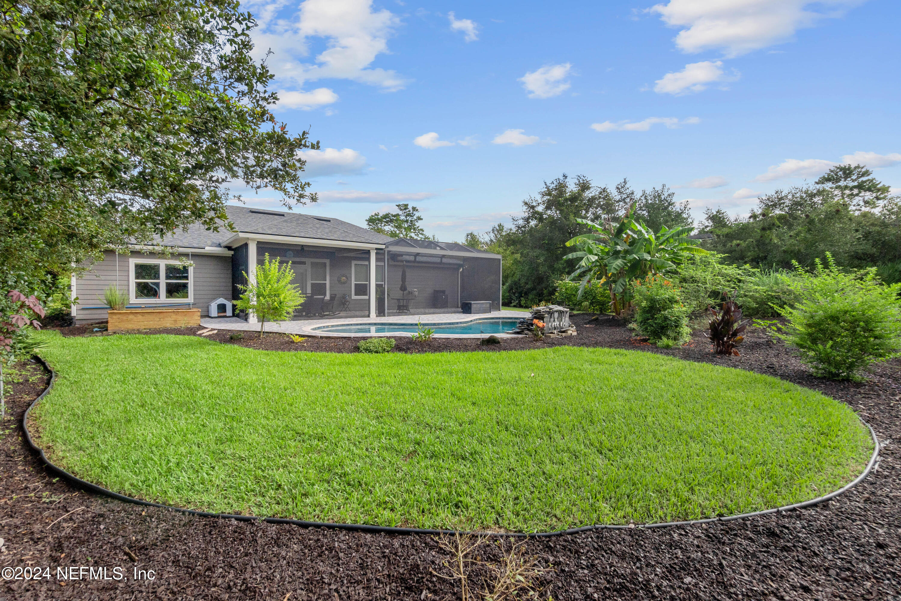 847 Oak Ridge Road St. Augustine, FL 32086 - Photo 28 of 36 a view of a house with a backyard porch and sitting area