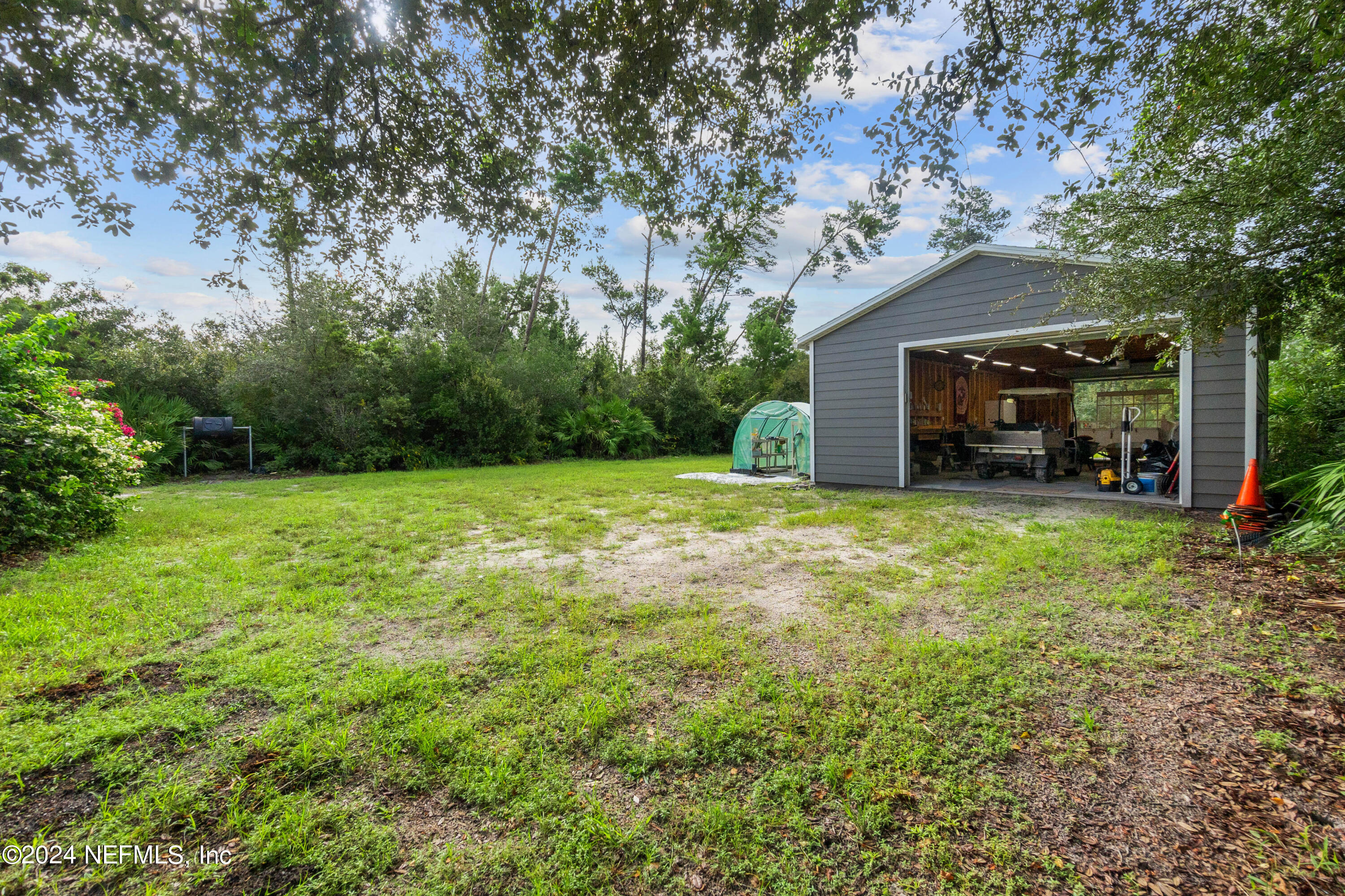 847 Oak Ridge Road St. Augustine, FL 32086 - Photo 29 of 36 a view of a backyard with a small cabin