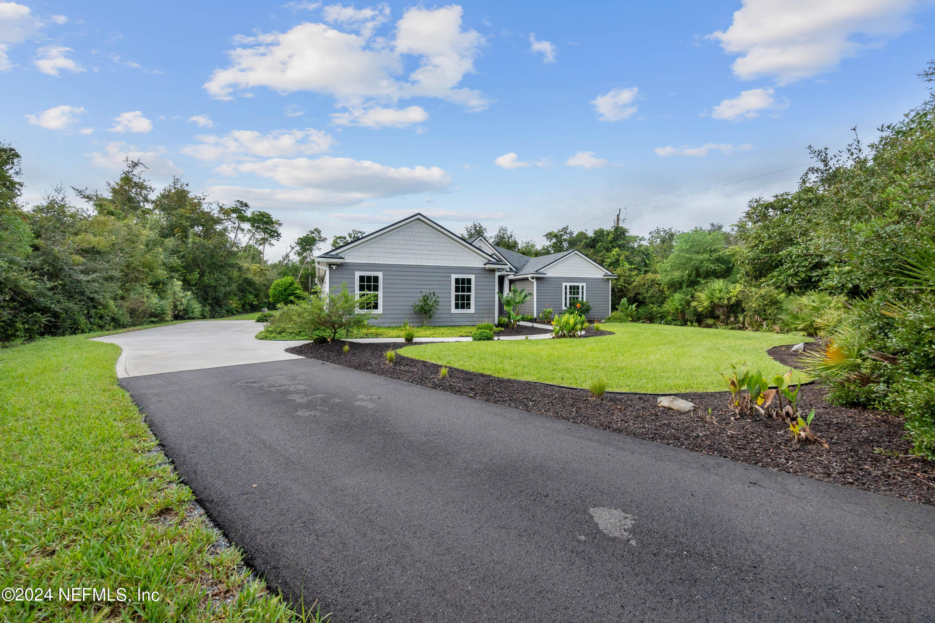 847 Oak Ridge Road St. Augustine, FL 32086 - Photo 3 of 36 a view of a house with a big yard and large trees
