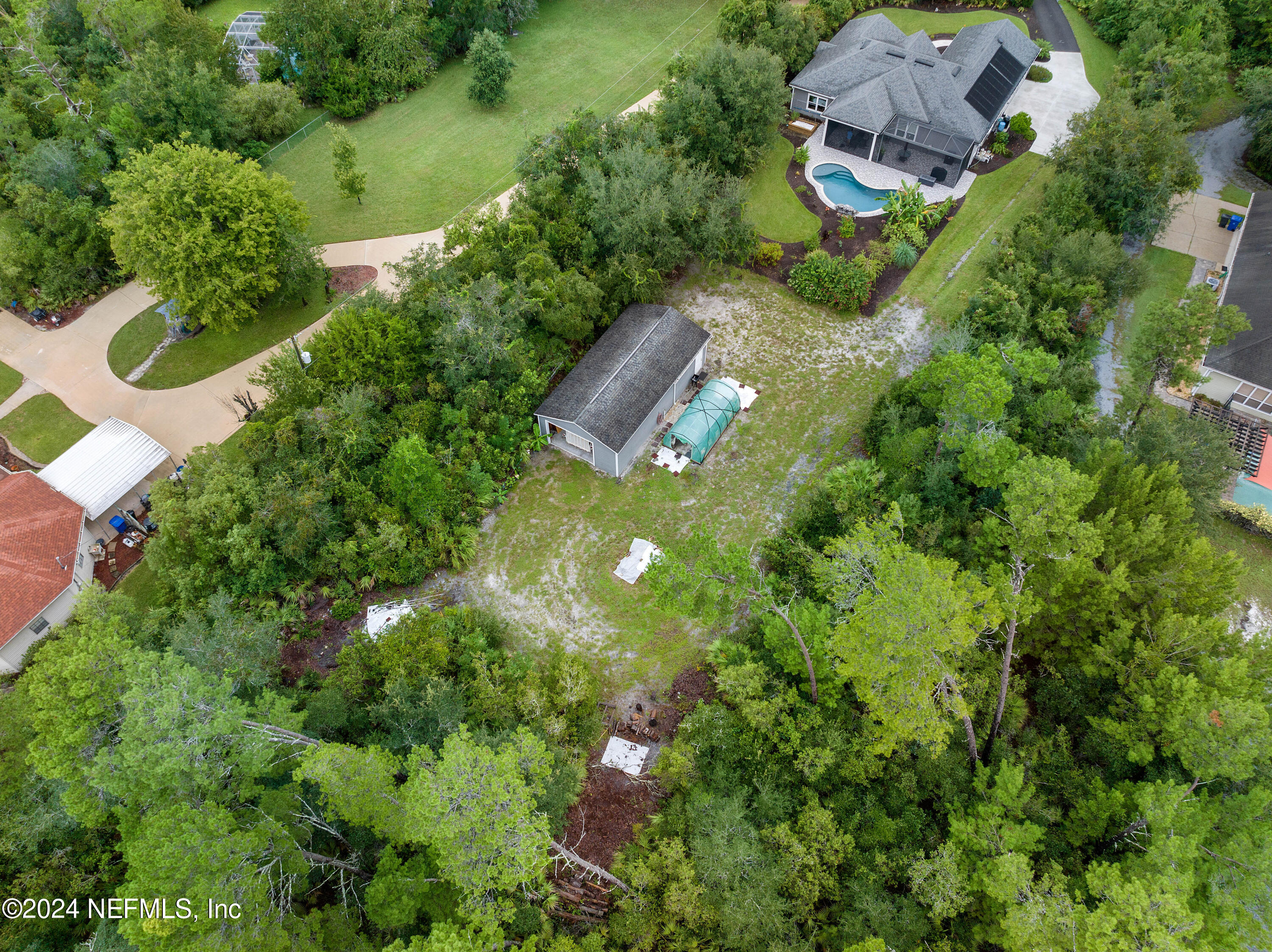 847 Oak Ridge Road St. Augustine, FL 32086 - Photo 34 of 36 an aerial view of residential houses with outdoor space and trees all around
