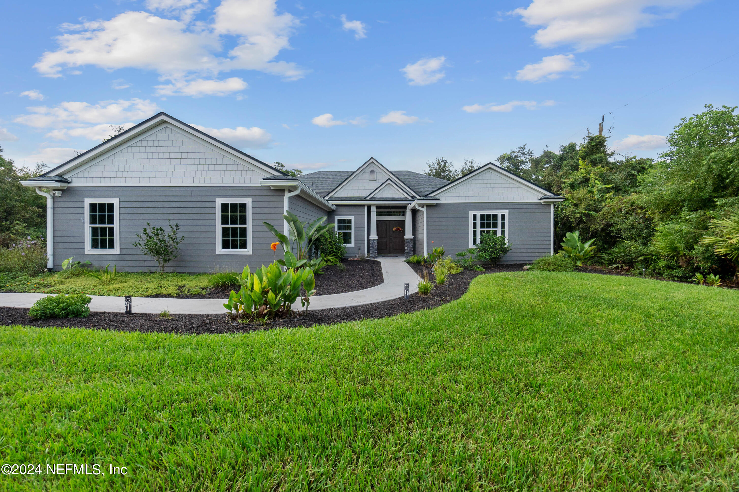 847 Oak Ridge Road St. Augustine, FL 32086 - Photo 5 of 36 a front view of house with yard and green space