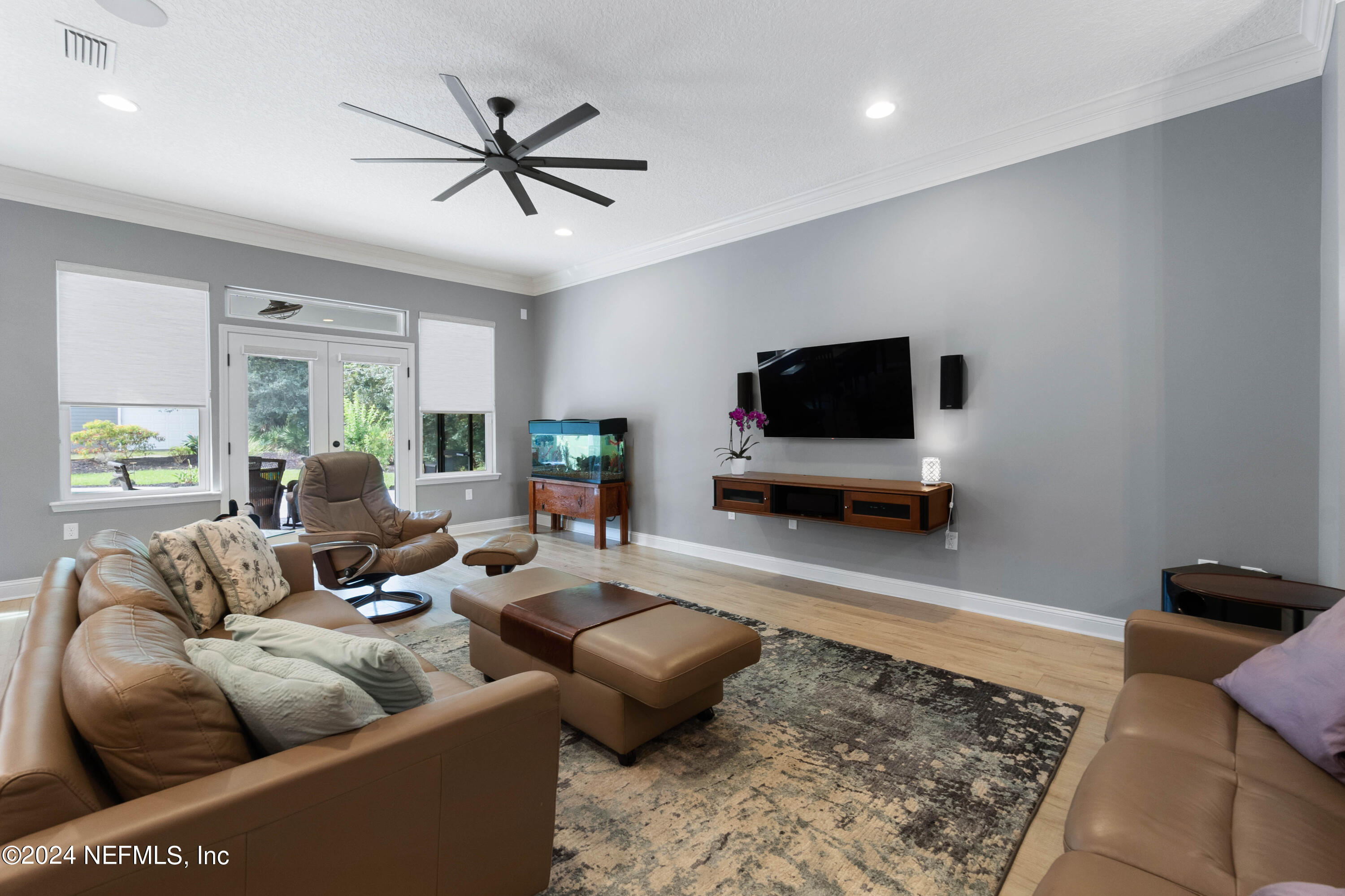 847 Oak Ridge Road St. Augustine, FL 32086 - Photo 9 of 36 a living room with furniture and a flat screen tv