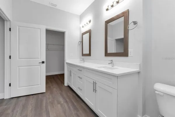 a bathroom with a double vanity sink and mirror