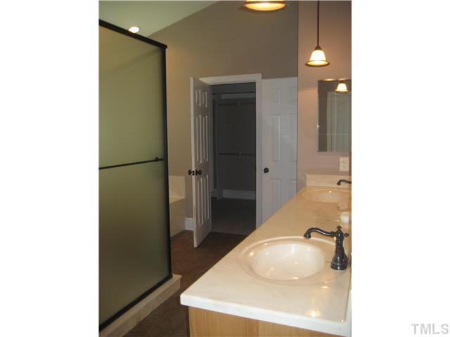 9619 Barton Creek Road Raleigh, NC 27615 - Photo 8 of 11 a bathroom with a sink and a mirror