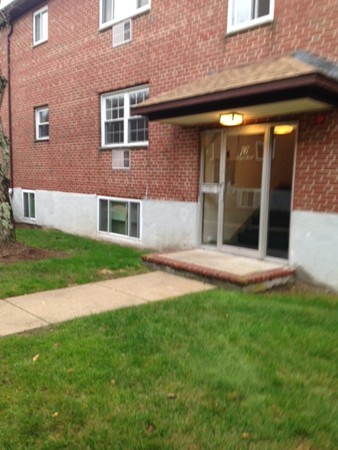 76 Bryon Road, Unit 3 Boston, MA 02467 - Photo 2 of 7 a front view of a house with a yard